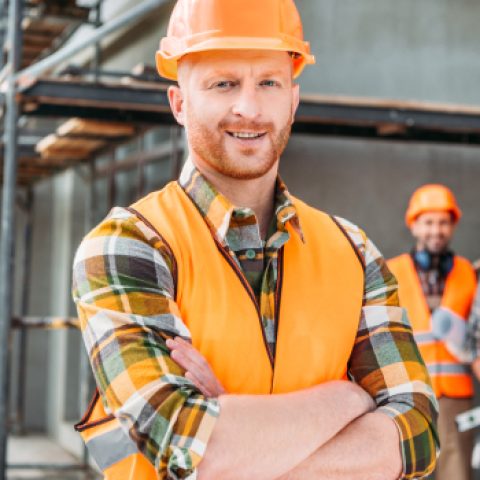 smiling-builder-standing-at-construction-site-with-2021-08-30-19-58-46-utc.jpg